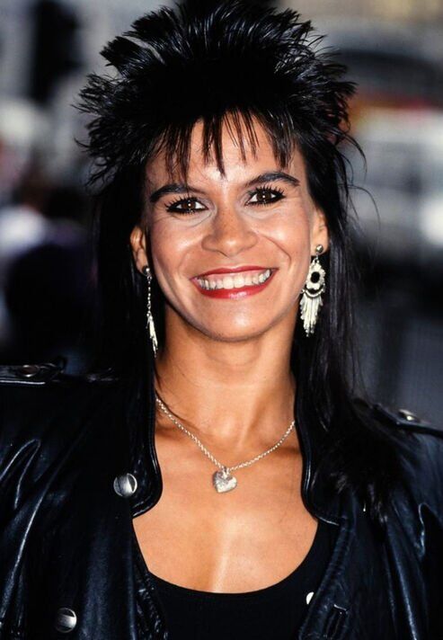 Falcon with her trademark hair style, smile and leather jacket.